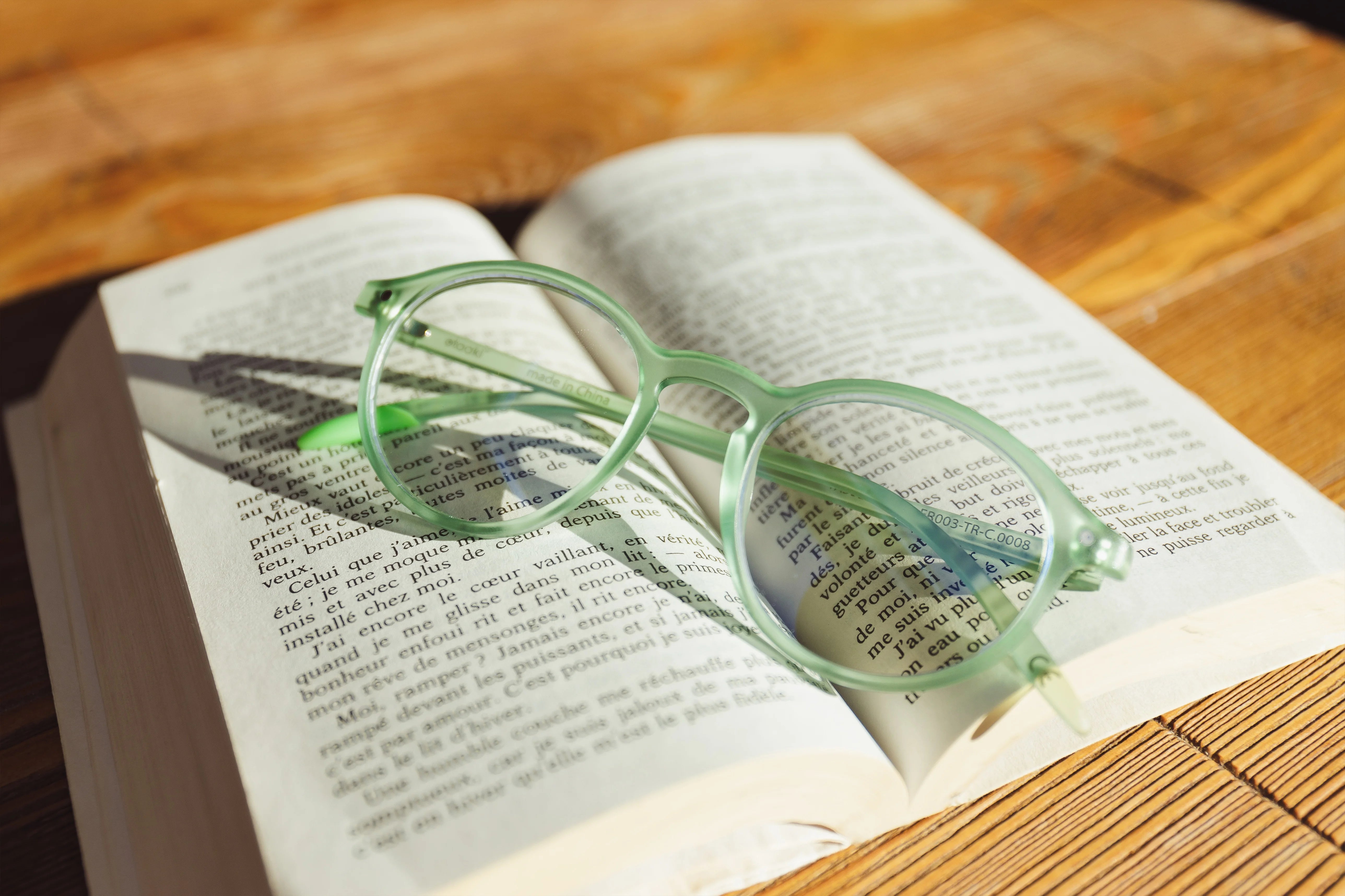 Photograph of an INFINITY frame placed on the pages of an open book.